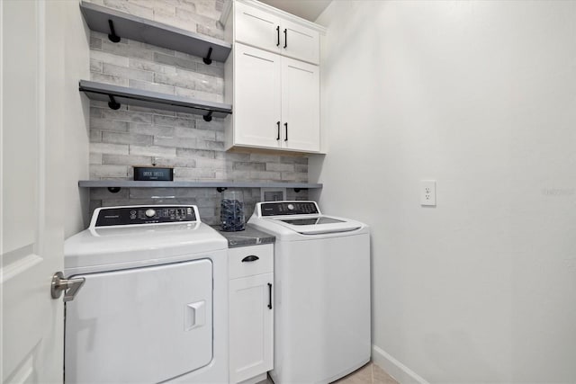 washroom with cabinets and separate washer and dryer