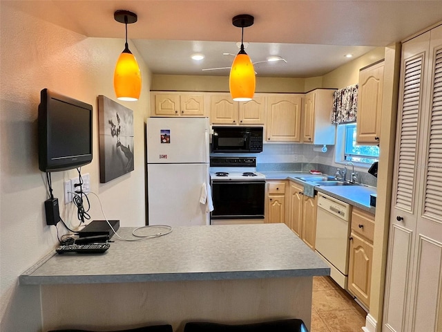 kitchen featuring sink, white appliances, and hanging light fixtures