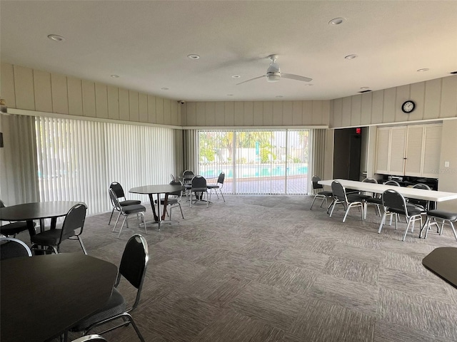 carpeted dining area featuring ceiling fan