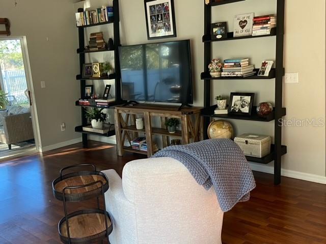 living room with radiator heating unit and dark wood-type flooring