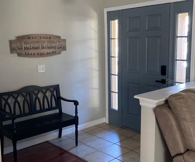 tiled foyer featuring a healthy amount of sunlight