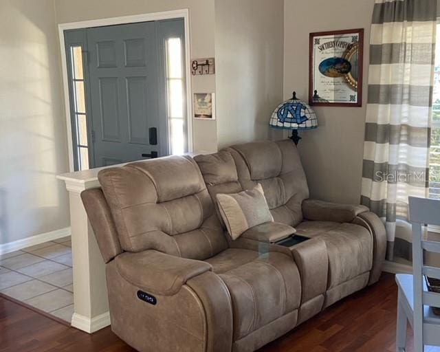 living room with a healthy amount of sunlight and dark hardwood / wood-style flooring