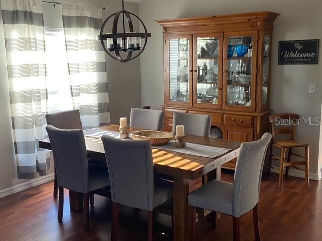 dining room featuring dark hardwood / wood-style floors and a notable chandelier