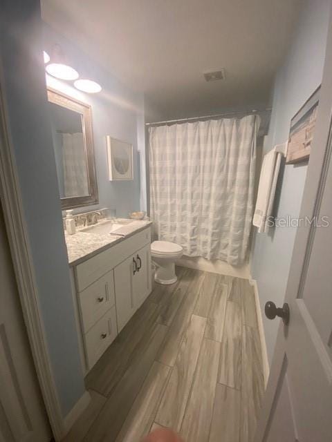 full bathroom with vanity, toilet, and shower / bath combo with shower curtain