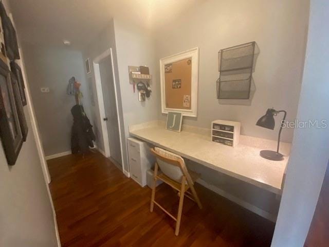 office area with built in desk and dark hardwood / wood-style floors