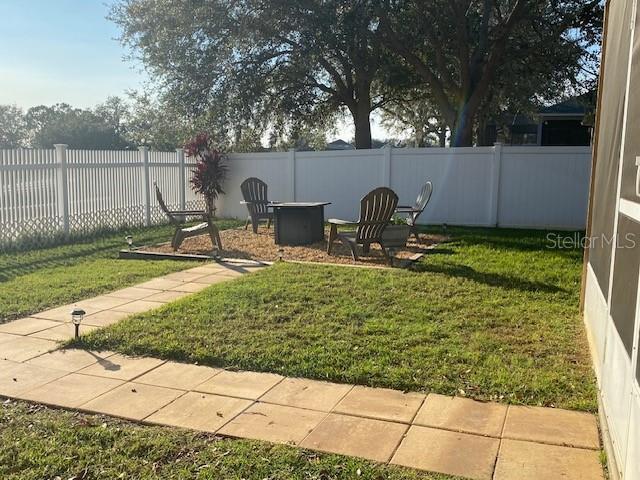 view of yard with an outdoor fire pit