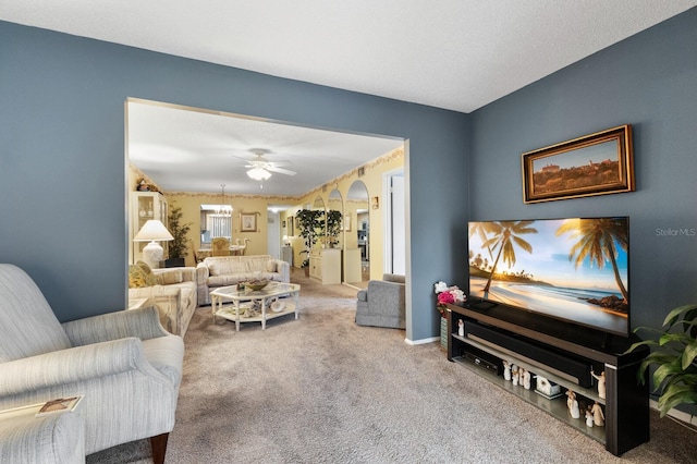 carpeted living room featuring a textured ceiling and ceiling fan