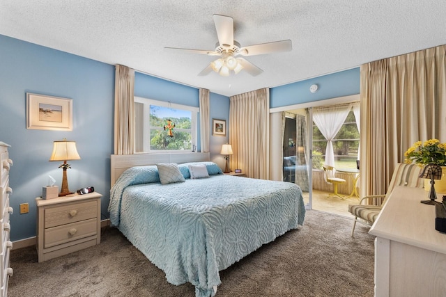 carpeted bedroom featuring multiple windows, ceiling fan, and a textured ceiling