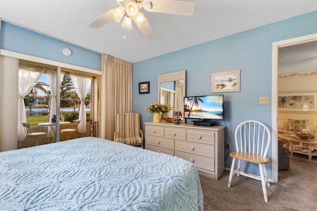 carpeted bedroom featuring ceiling fan and a textured ceiling