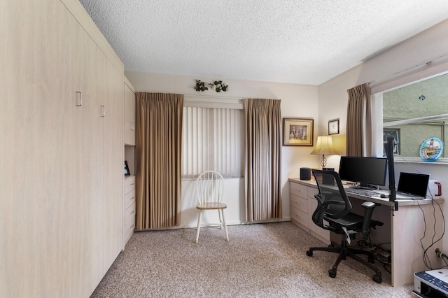 office area with light colored carpet and a textured ceiling