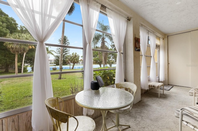 sunroom with a water view and plenty of natural light