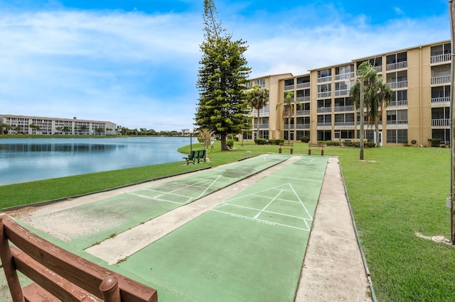 view of home's community with a yard and a water view