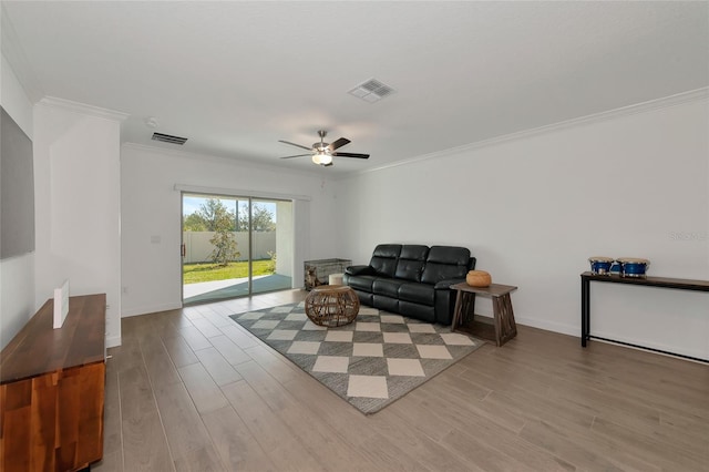 living room featuring ornamental molding, ceiling fan, and light hardwood / wood-style floors