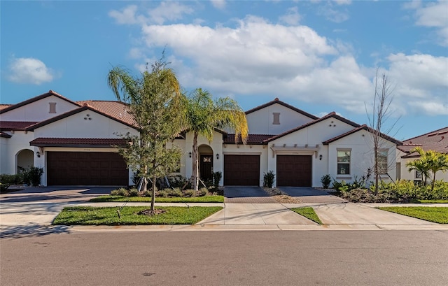 mediterranean / spanish-style house with a garage