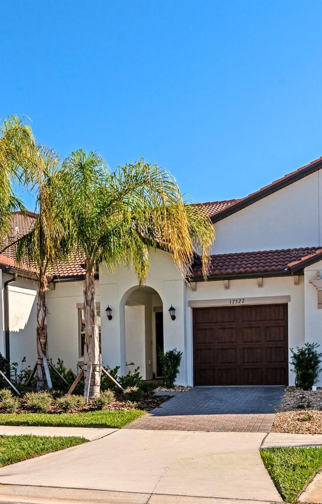 mediterranean / spanish-style house with a garage