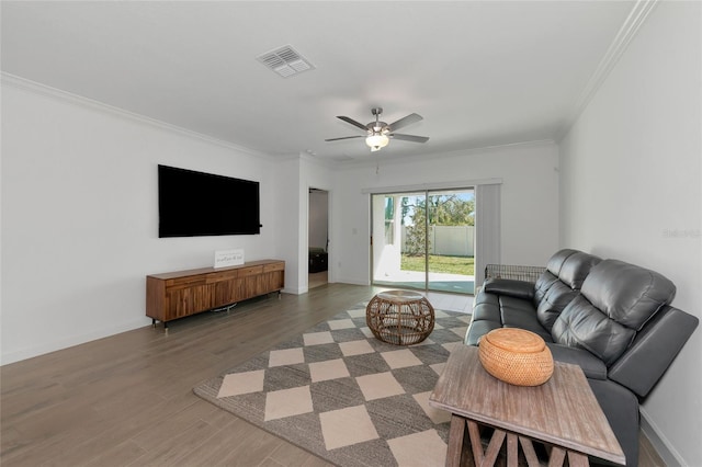 living room with ceiling fan, crown molding, and wood-type flooring