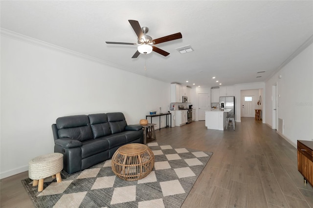 living room with ceiling fan, light hardwood / wood-style floors, and crown molding