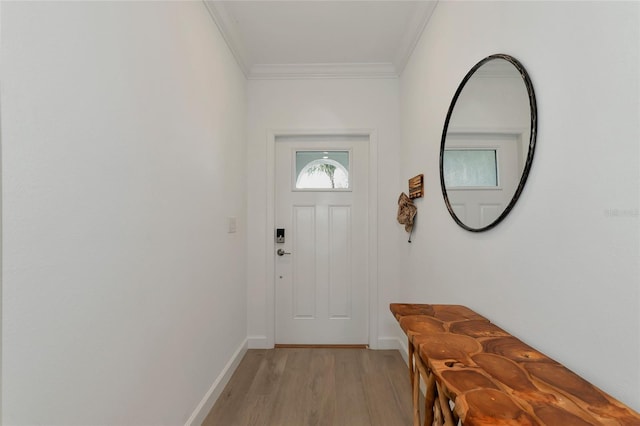 doorway to outside featuring ornamental molding and light hardwood / wood-style flooring