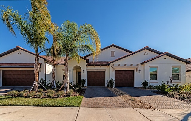 mediterranean / spanish-style house with a garage