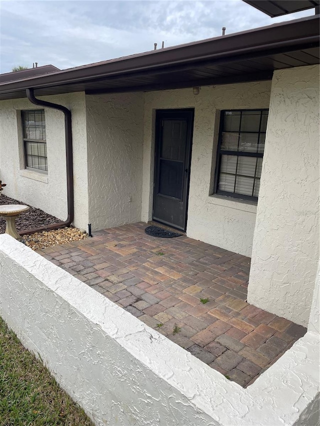 doorway to property with a patio area