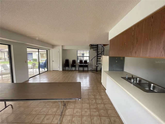 kitchen featuring sink and a textured ceiling