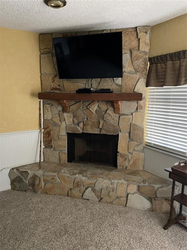 interior details with a fireplace and a textured ceiling