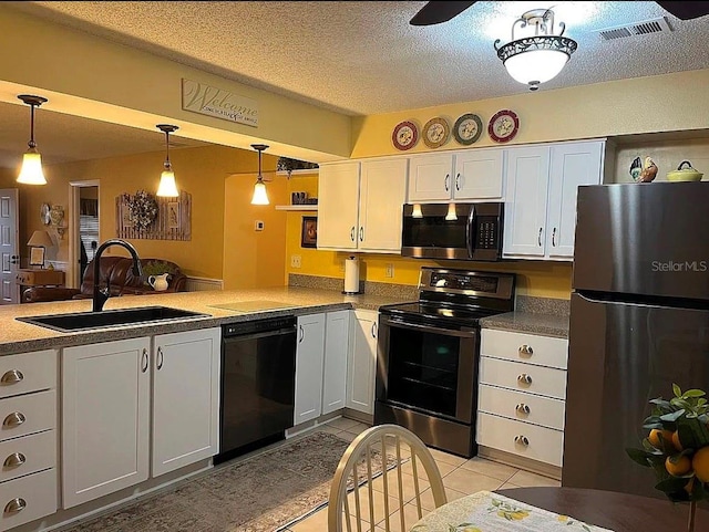 kitchen featuring appliances with stainless steel finishes, pendant lighting, sink, white cabinets, and kitchen peninsula