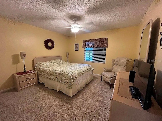 carpeted bedroom featuring a textured ceiling and ceiling fan