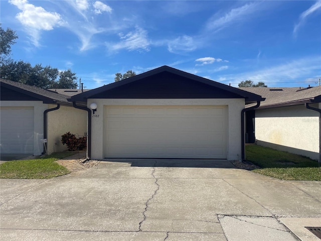 garage featuring concrete driveway