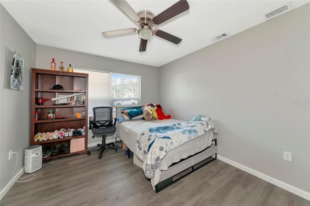 bedroom with ceiling fan and hardwood / wood-style flooring