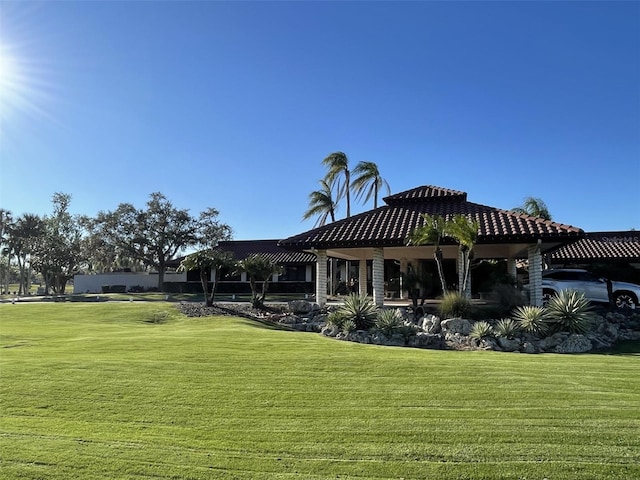 rear view of property featuring a lawn and a gazebo