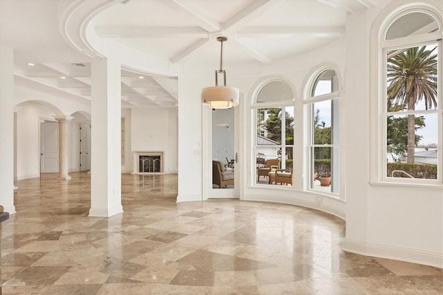 unfurnished dining area with decorative columns, coffered ceiling, a wealth of natural light, and beamed ceiling