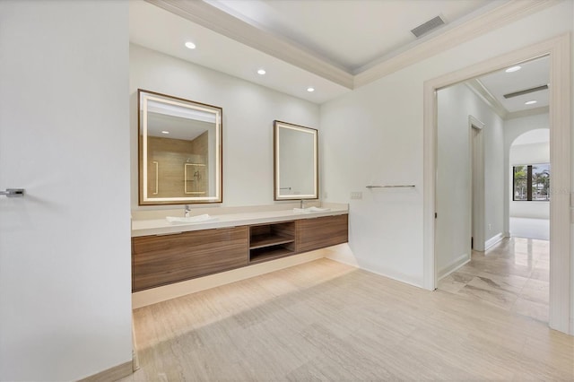 bathroom featuring crown molding and vanity