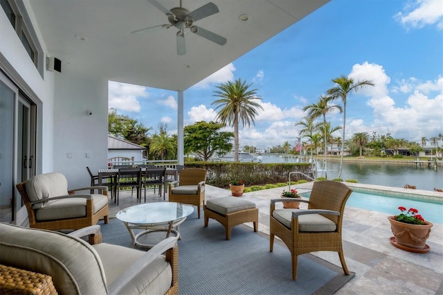 view of patio with a water view, ceiling fan, and outdoor lounge area