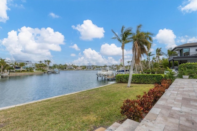 dock area featuring a water view and a lawn