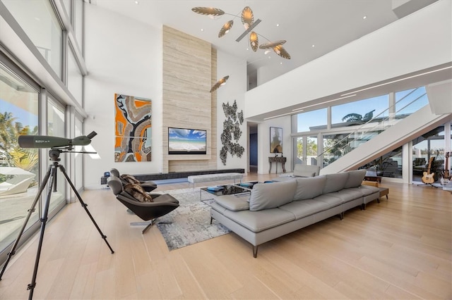 living room featuring a high ceiling and light hardwood / wood-style floors