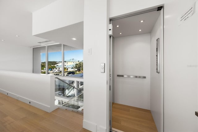 interior space featuring hardwood / wood-style floors and elevator