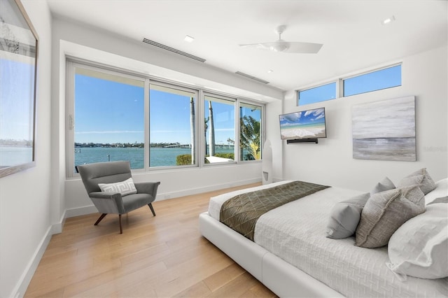 bedroom with ceiling fan and light hardwood / wood-style floors