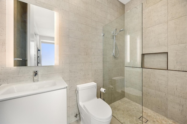 bathroom featuring tile walls, toilet, and a tile shower