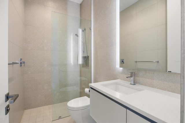 bathroom featuring tile walls, backsplash, vanity, walk in shower, and toilet