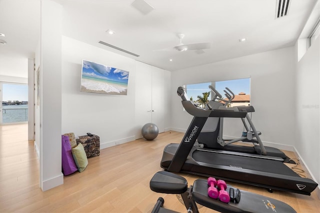 workout room featuring light wood-type flooring