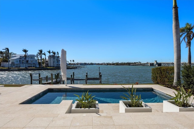 view of pool with an in ground hot tub, a boat dock, and a water view