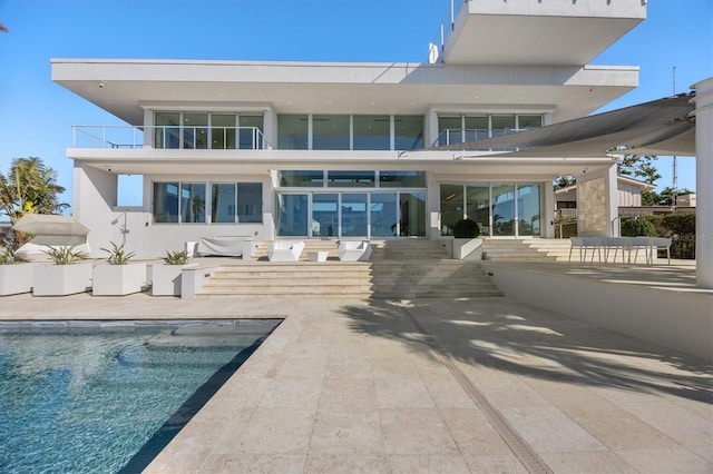 back of house featuring a patio and a balcony