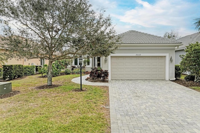 view of front of home featuring a garage and a front lawn