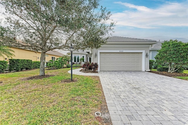 ranch-style house featuring a garage and a front yard