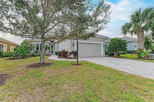 ranch-style home with a garage and a front yard