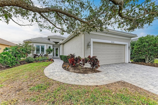 view of front of house with a garage and a front yard