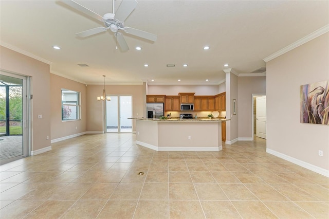 kitchen with appliances with stainless steel finishes, ceiling fan with notable chandelier, hanging light fixtures, light tile patterned floors, and crown molding