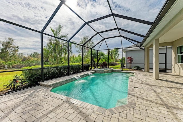 view of pool featuring a patio, a lanai, pool water feature, and an in ground hot tub