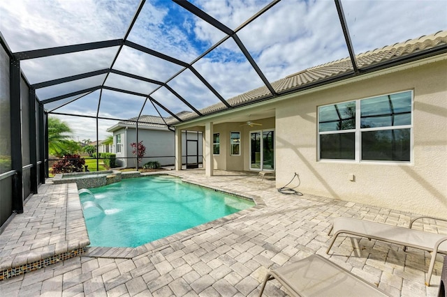 view of swimming pool featuring a patio, a lanai, and ceiling fan